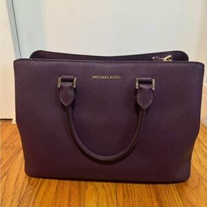 Plum colored Michael Kors purse with crossbody strap
